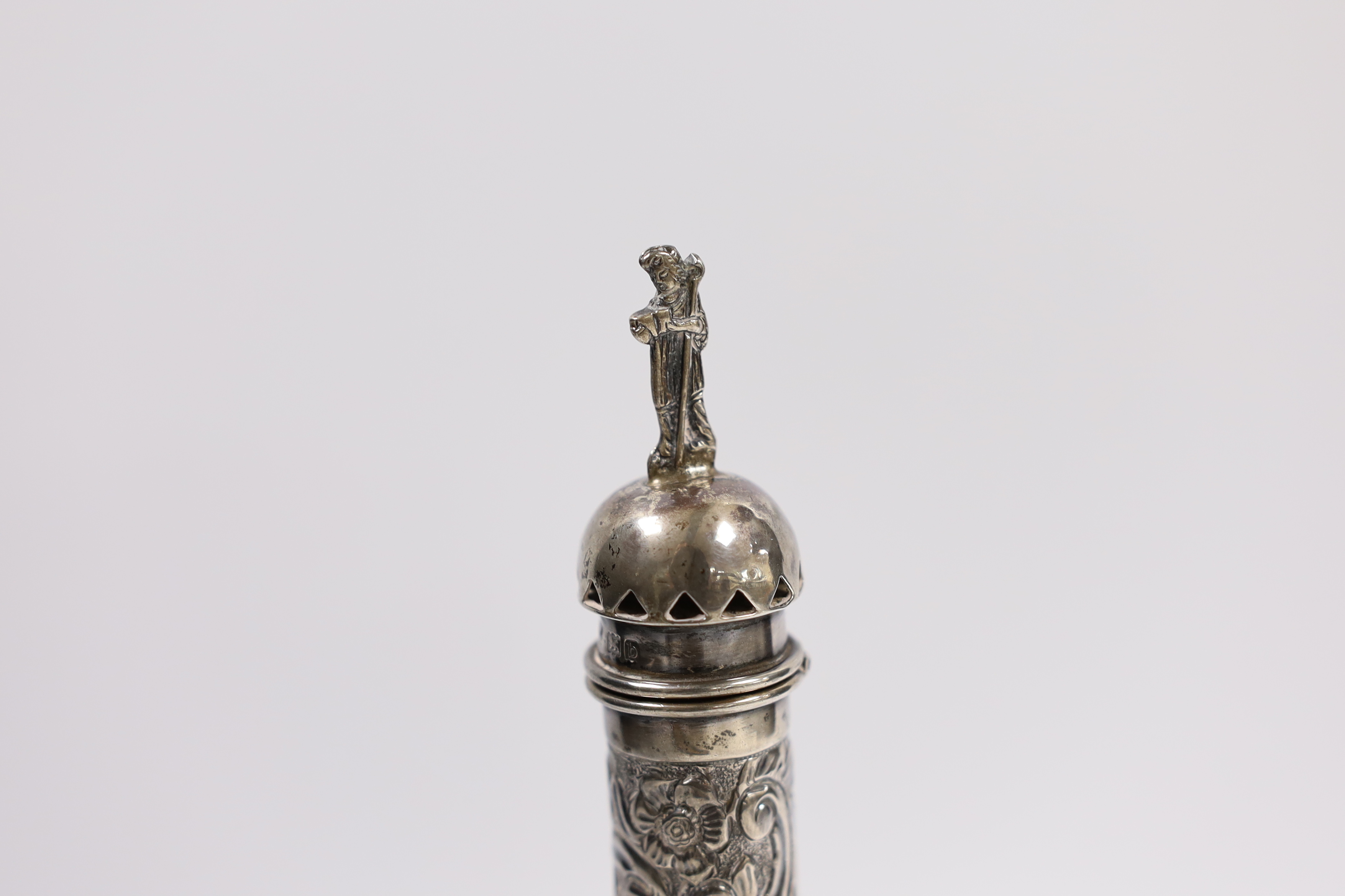 A late Victorian repousse silver sealing wax and match holder, with figural finial, Samuel Jacob, London, 1897, 20.7cm, a silver vesta case, two spoons and a silver napkin ring.